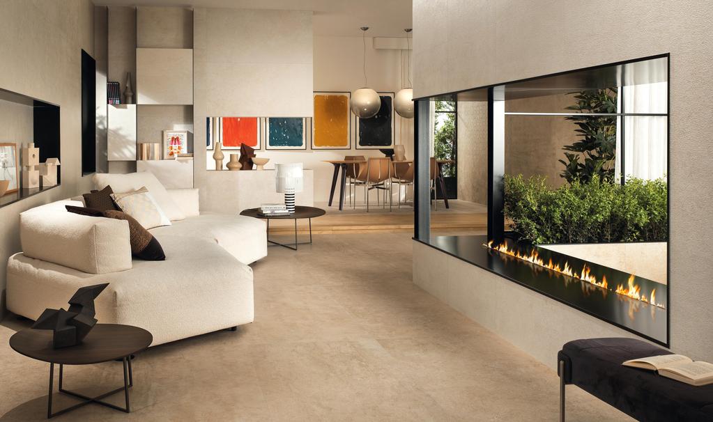 Salotto moderno con pavimento in gres effetto pietra calcarea Limestone e caminetto integrato.