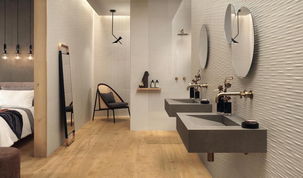 Bathroom with light wood effect floor, suspended washbasins, round mirrors and walls covered in white tiles 3D effect.  
